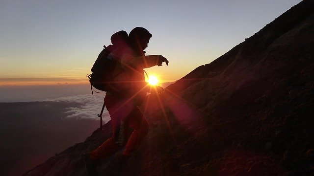 hiker reaching summit